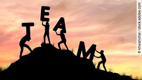 silhouette team work of men helping and lifting word, concept as