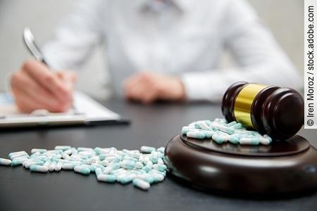 Medicine law concept. Judges gavel with pills